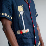 Close up of left side of shirt on a male model in a studio