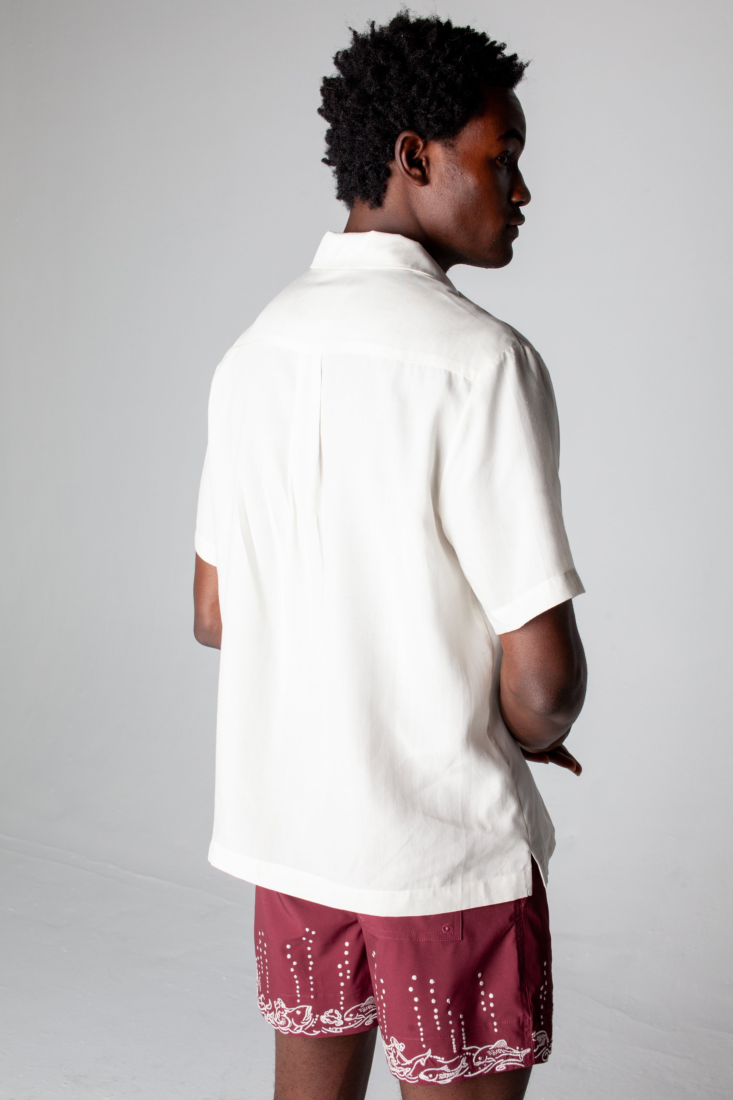 Back view of male model wearing shirt with matching shorts