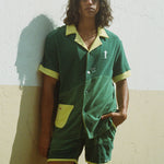 Male model wearing full set standing against a wall