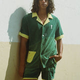 Male model wearing full set standing against a wall