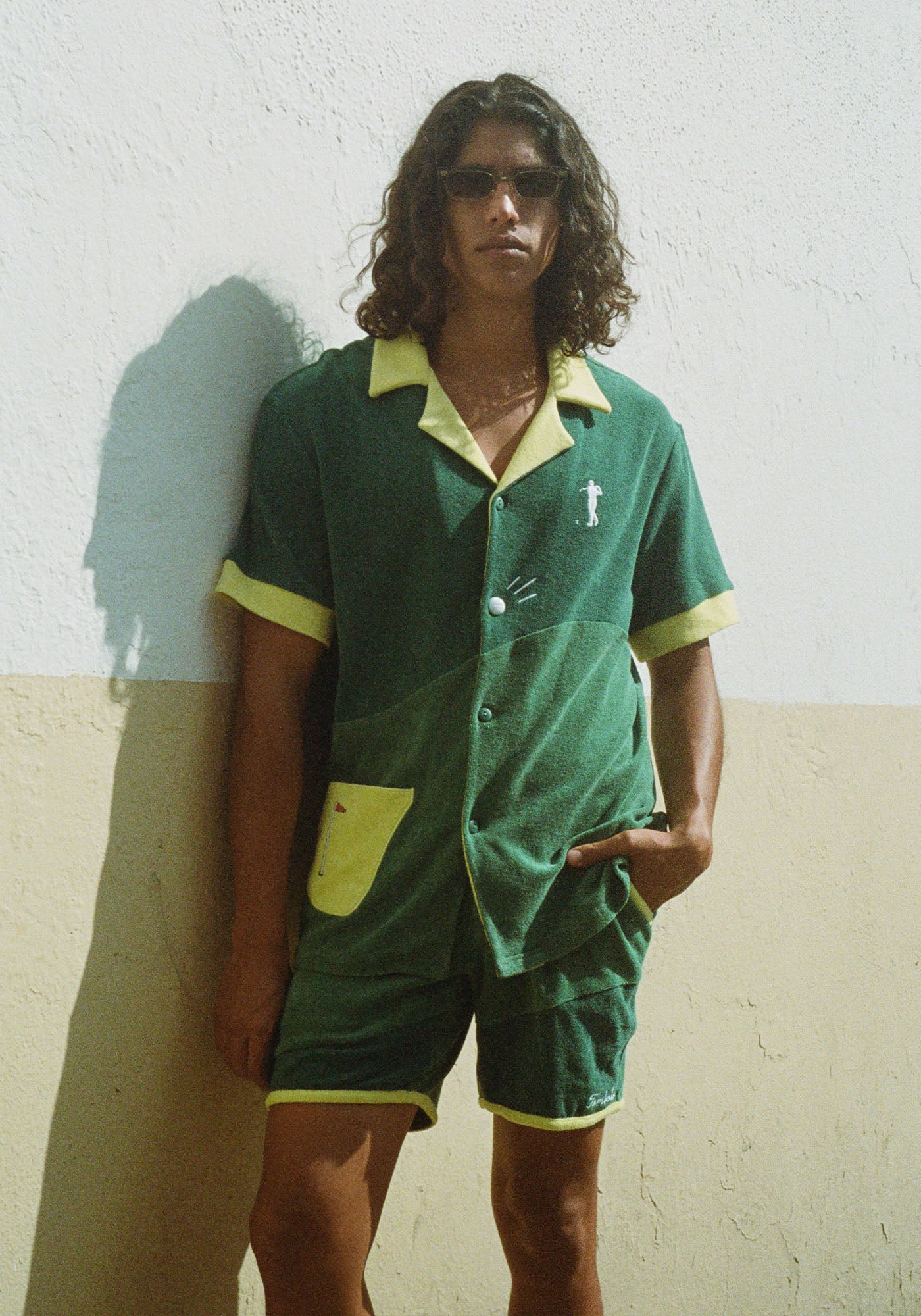 Male model wearing full set standing against a wall