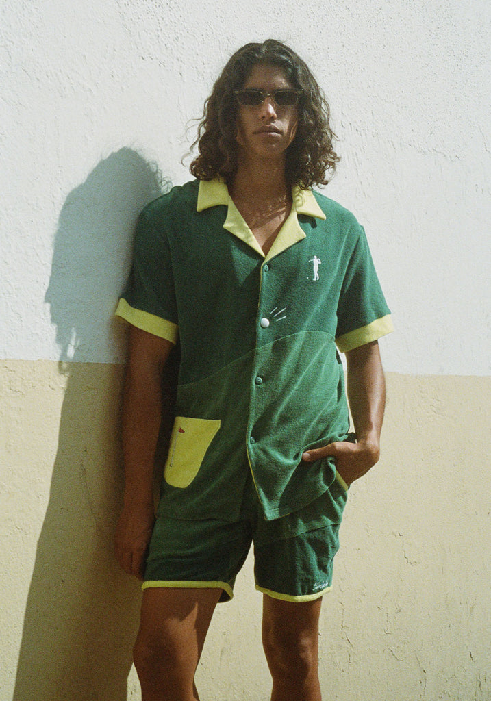 Male model wearing full set standing against a wall