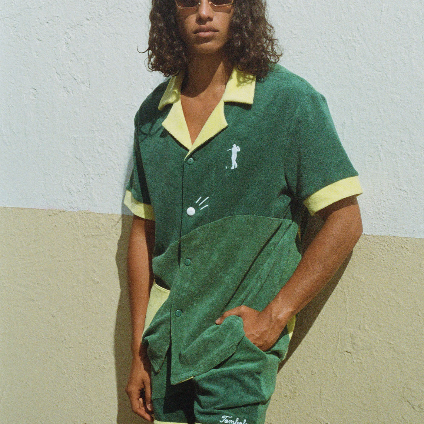 Man puts hand in pocket and stares at camera while wearing full matching set