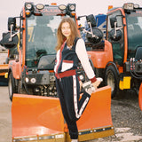 Female model stretching in set in front of snow plow