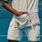 Male model with hand in front pocket on tennis court