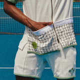 Male model with hand in front pocket on tennis court