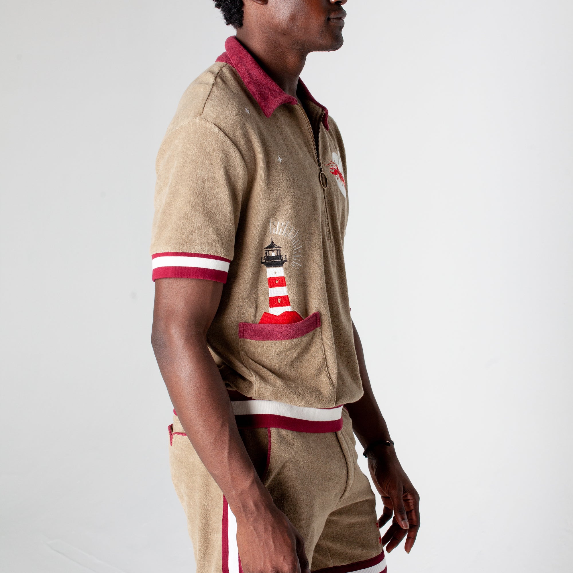 Embroidered with lighthouse emerging from the pocket and a flying lobster eclipsing the moon in organic cotton terry cloth as the perfect cabana shirt