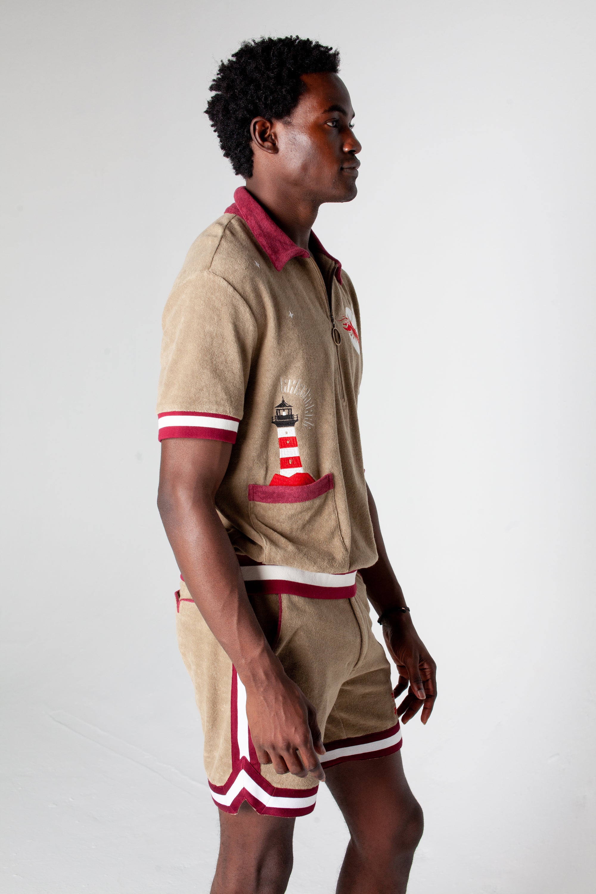 Embroidered with lighthouse emerging from the pocket and a flying lobster eclipsing the moon in organic cotton terry cloth as the perfect cabana shirt