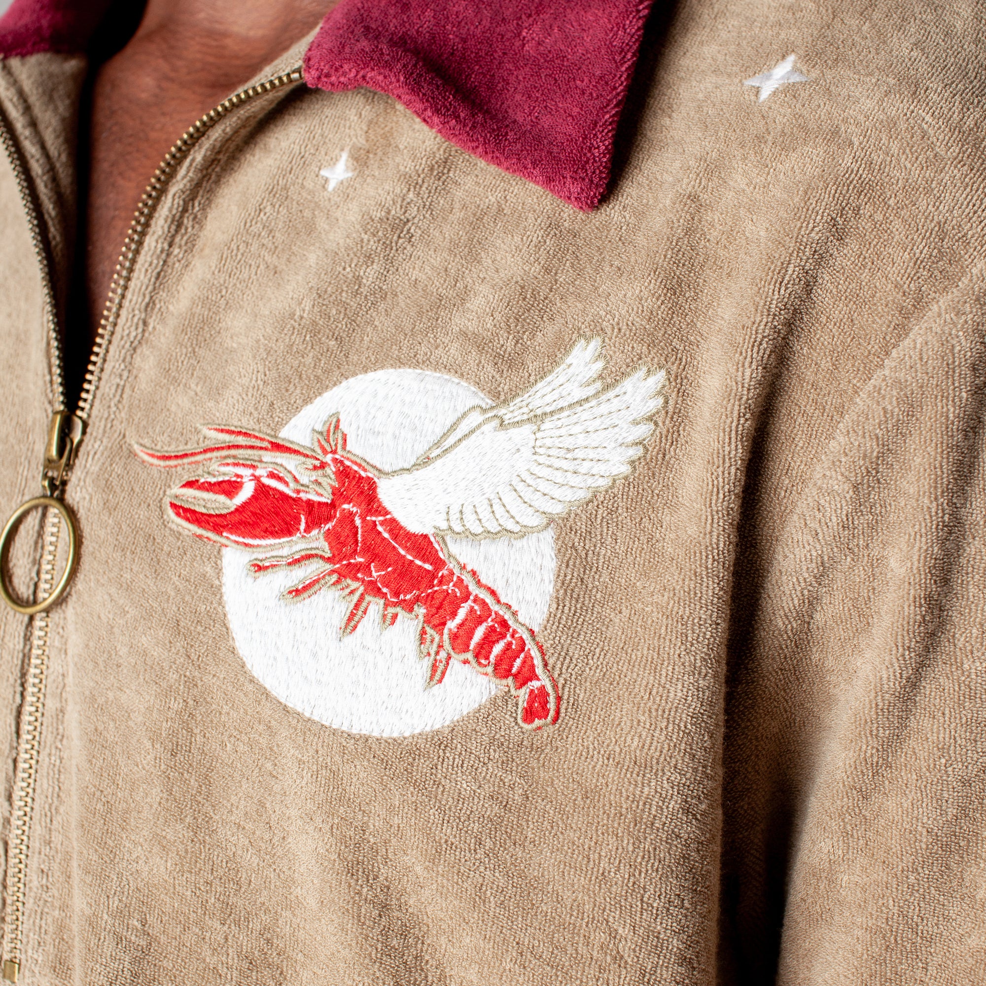 fun playful lobster motif embroidered into organic cotton terry cloth eclipsing the moon amidst a starry night perfect for day or night