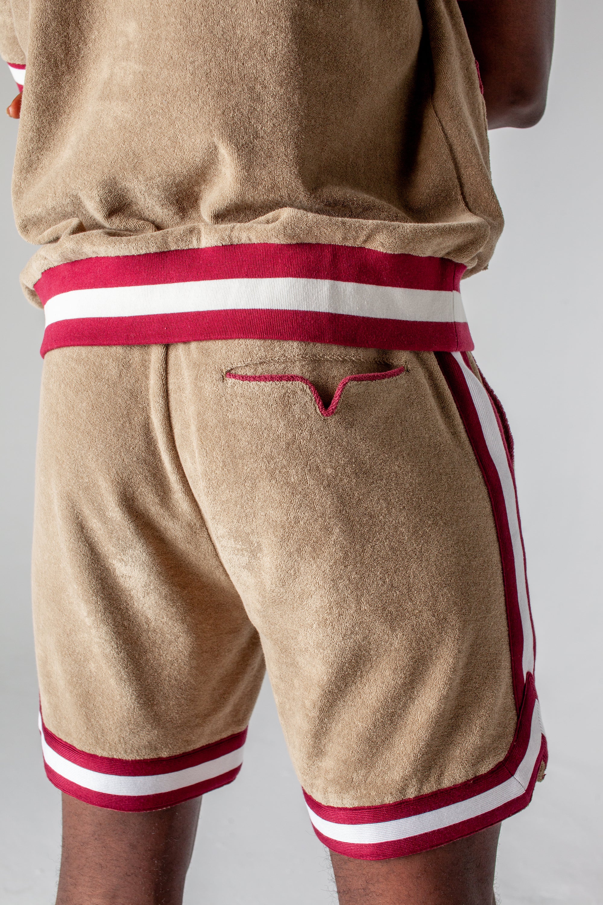 back view of shorts on male model showing signature v pocket and red piping
