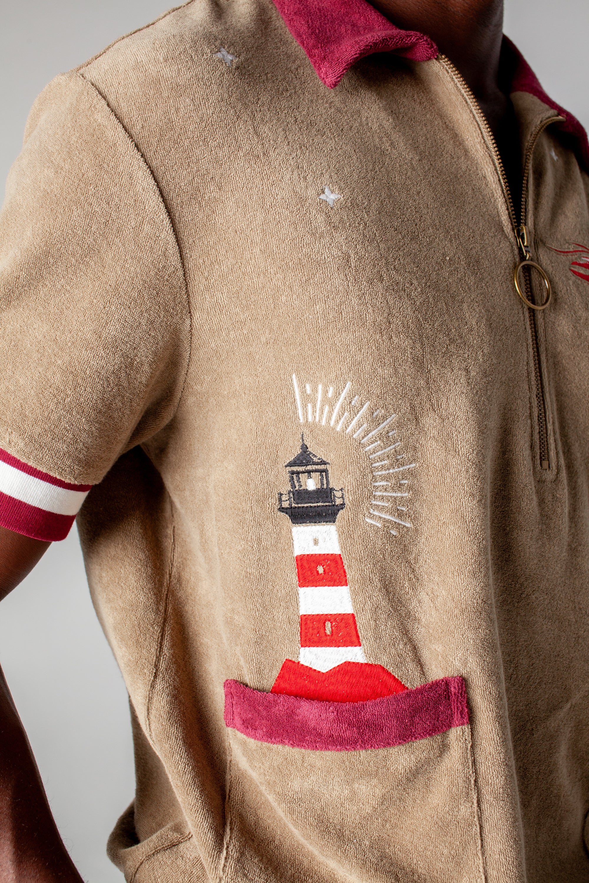 organic cotton terry cloth cabana shirt brings an emrbroidered lighthouse motif to this stylish and playful caban shirt that is a part of a matching set perfect for seaside escape