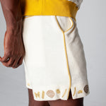 Side close up of man wearing vongole shorts with waistband of matching shirt showing