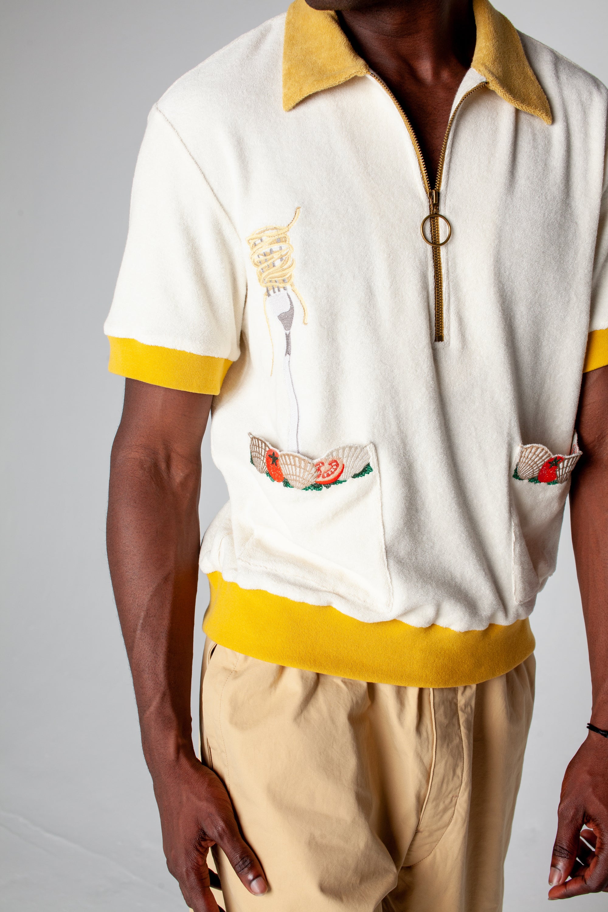 featuring an embroidered fork with pasta and edge embroidered pockets with classic ingredients, this organic cotton terry cloth cabana shirt is sure to have you dining in style