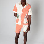 Full body shot of a male model wearing the matching Gusanito shirt and shorts