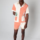 Full body shot of a male model wearing the matching Gusanito shirt and shorts