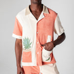Full body image of male model wearing the Gusanito cabana set, with his hand in the outer right pocket