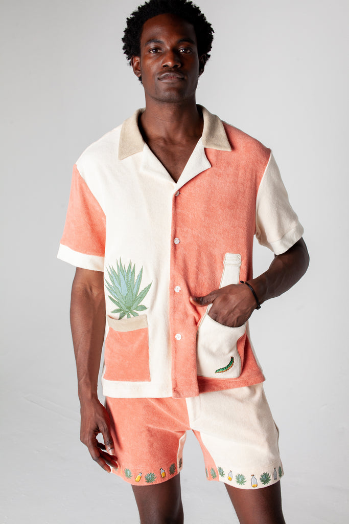 Full body image of male model wearing the Gusanito cabana set, with his hand in the outer right pocket