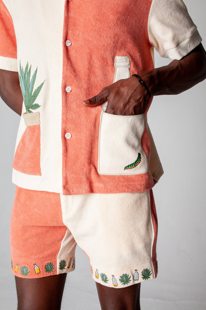 Close up of male model with his hand in right tequila bottle pocket