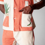 Close up of the male model wearing the full Gusanito set with his hand in the front pocket