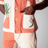 Close up of the male model wearing the full Gusanito set with his hand in the front pocket
