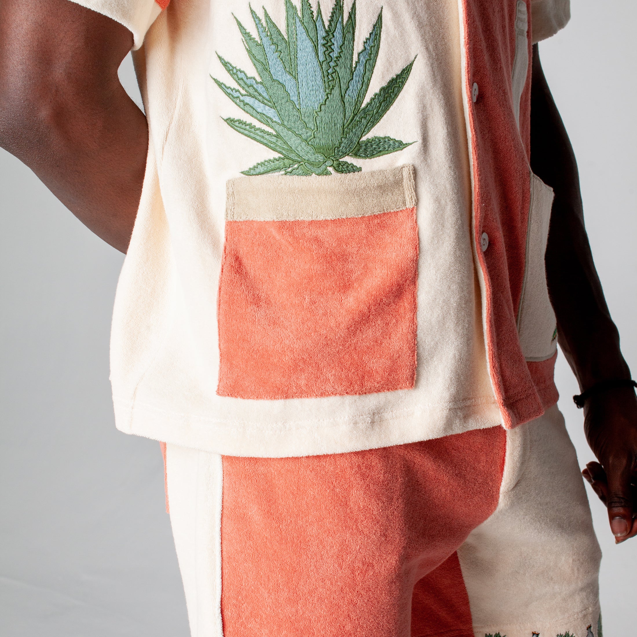 Left side of the Tombolo Gusanito tequila shirt featuring s a fun agave plant embroidered, in which the pot doubles as a pocket