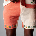 Close-up shot of a male model wearing the Gusanito shorts and top