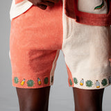 Close-up shot of a male model wearing the Gusanito shorts and top