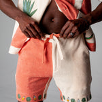 Another close-up of shorts on male model with bottom buttons of shirt opened showcasing midriff