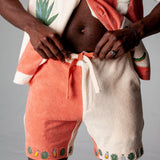 Another close-up of shorts on male model with bottom buttons of shirt opened showcasing midriff