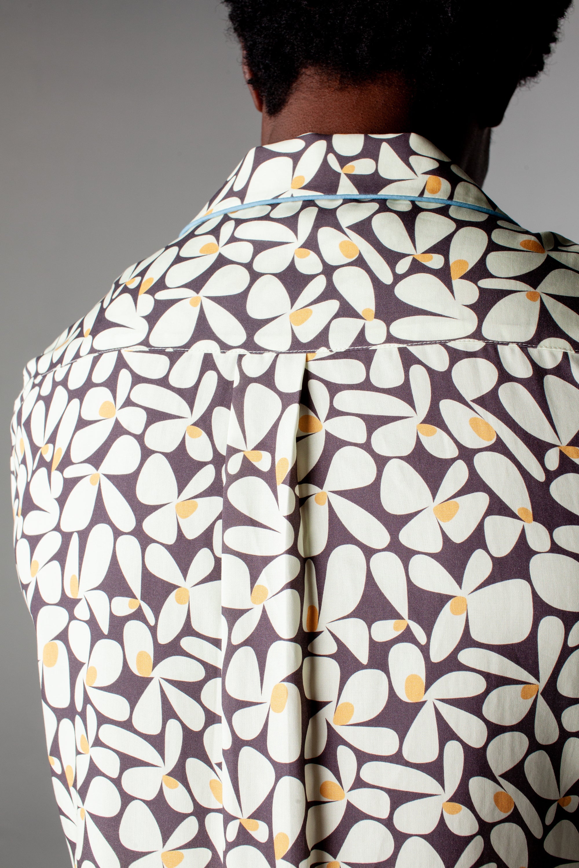 Close up of back of collar of shirt and box pleat on male model