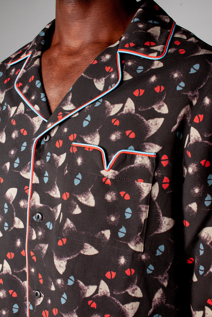Close up of shirt collar and pocket with red and blue piping