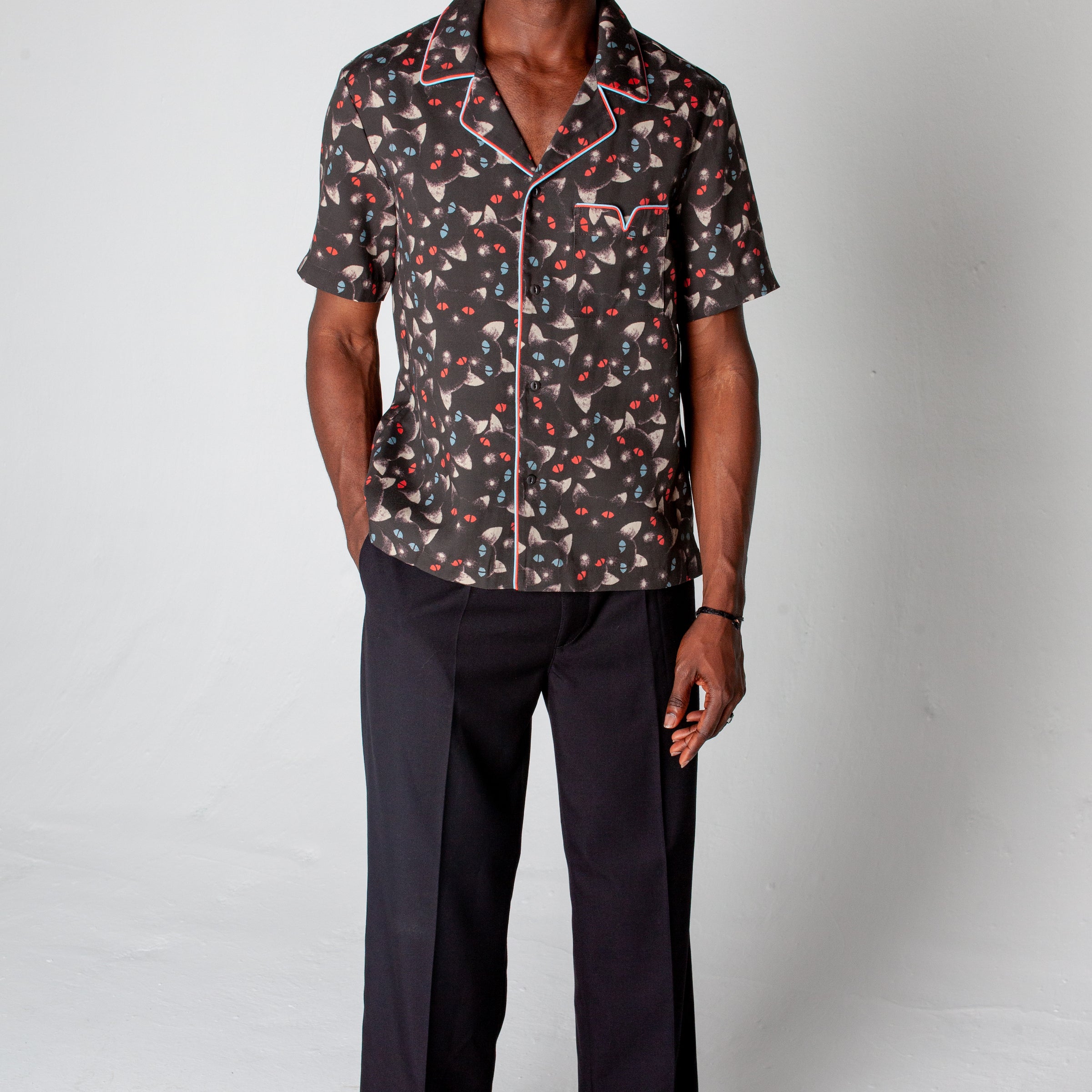 male model posing in shirt and black dress pants