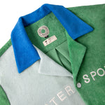 Close up of the blue collar and special tombolo x hotel magique tag