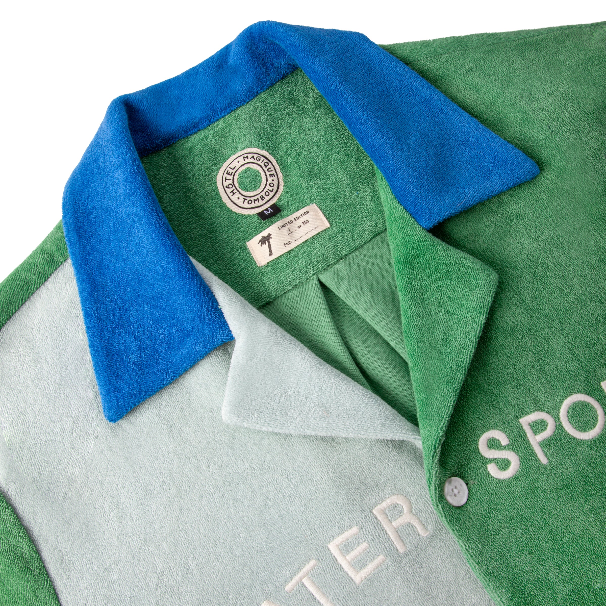 Close up of the blue collar and special tombolo x hotel magique tag